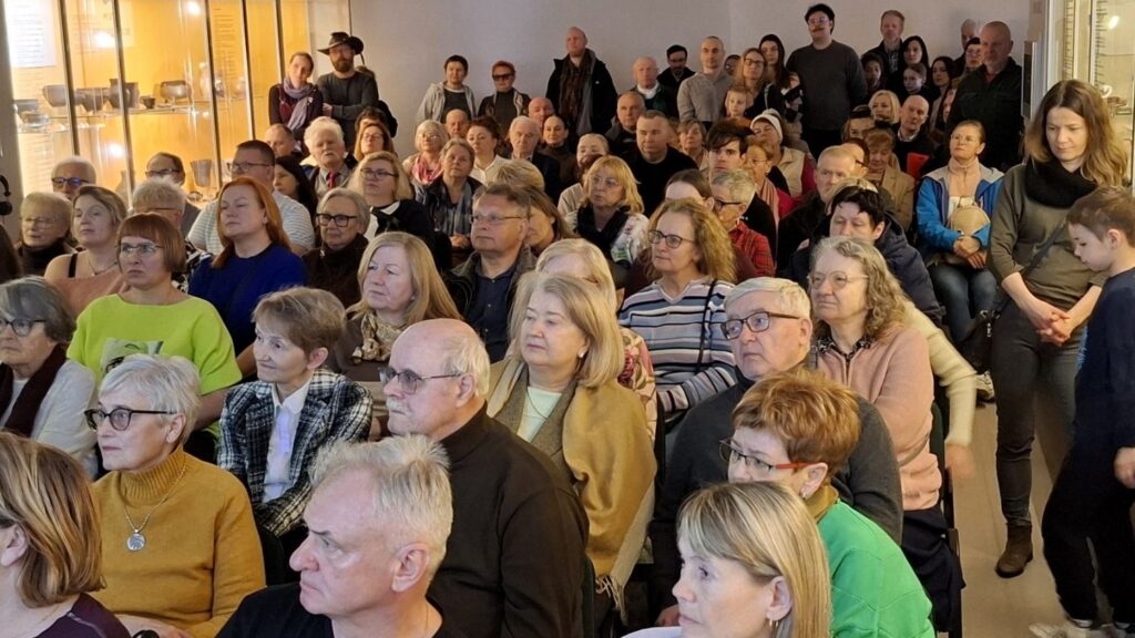 Licznie zgromadzona publiczność słucha wykładu w sali muzealnej (kliknięcie powiększy zdjęcie).